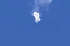 The suspected Chinese spy balloon drifts to the ocean after being shot down