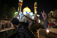 A demonstrator holds a replica missile shell as people gather in support of Iran's attack on Israel in Tehran's Palestine Square 