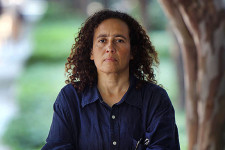 Neta Crawford standing with arms crossed